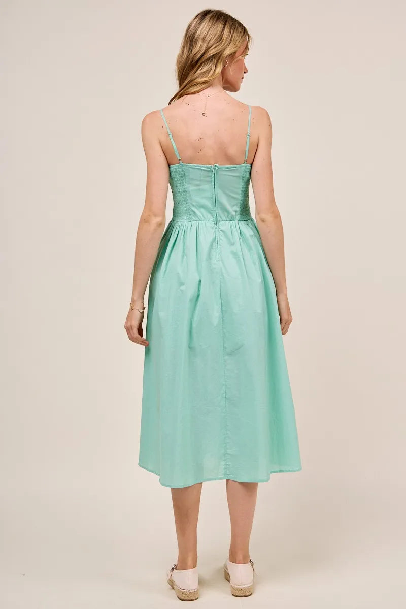 Back view of the Berkley Smocked Midi Dress in sage, featuring a zip-up closure and gathered detail at the waist for a flattering fit.