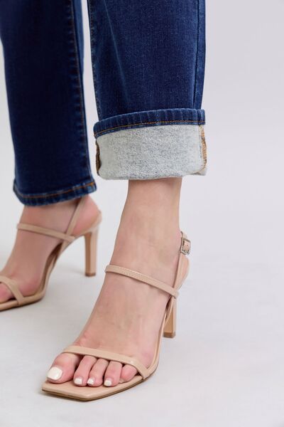 Close-up of Carson Straight Leg Jeans rolled at ankle, highlighting dark wash denim and straight fit.