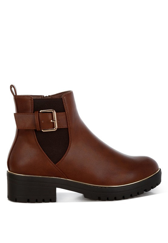 Side angle view of tan Antorin chunky buckle ankle boots with bold buckle and elastic gusset.