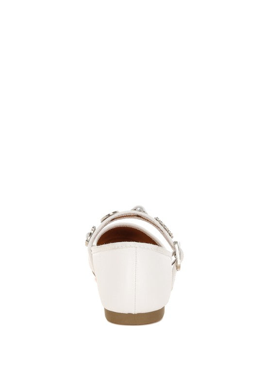 Back view of white Kavana Mary Jane Flats highlighting the heel and ankle strap buckle.