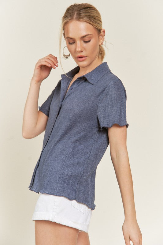 Side angle denim blue button down textured shirt, lettuce edge.