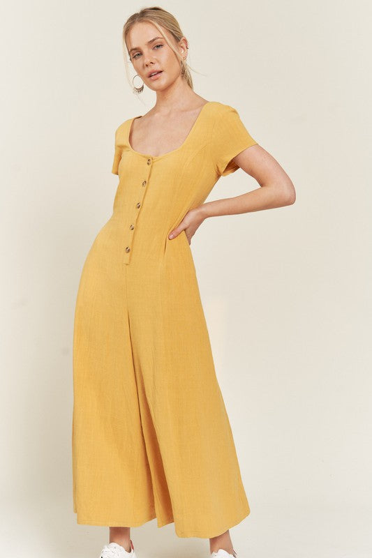Mustard Seona Linen Plus Size Jumpsuit front view with scoop neck and button-front closure.