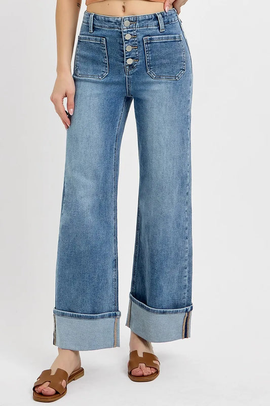 Straight-on front view of RISEN Asher jeans featuring high rise waist, front patch pockets, button fly, and wide leg with cuffed hem