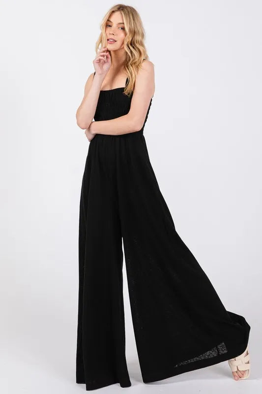 Black Wide Leg Jumpsuit with Smocked Top and Side Pockets - Blends Comfort with Contemporary Style.