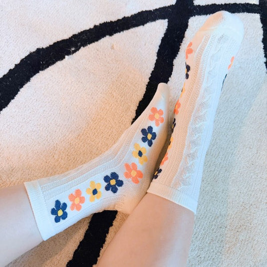 Woman wearing white Side Garden Flower Socks showing colorful side floral detail.