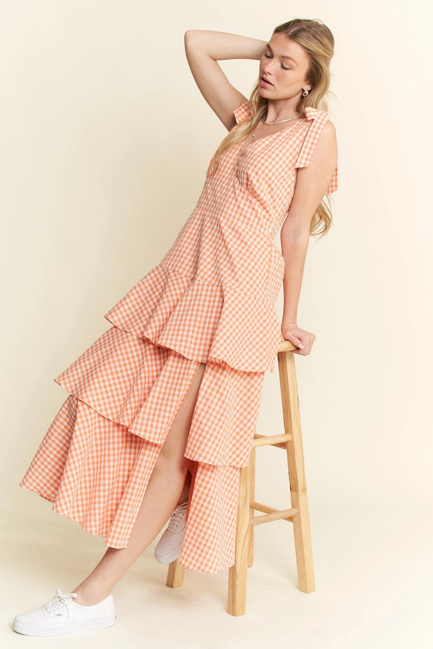 Full body side view of Alice Gingham Tiered Midi Dress by Jade by Jane, emphasizing side slit, tiered skirt, and playful orange gingham pattern.