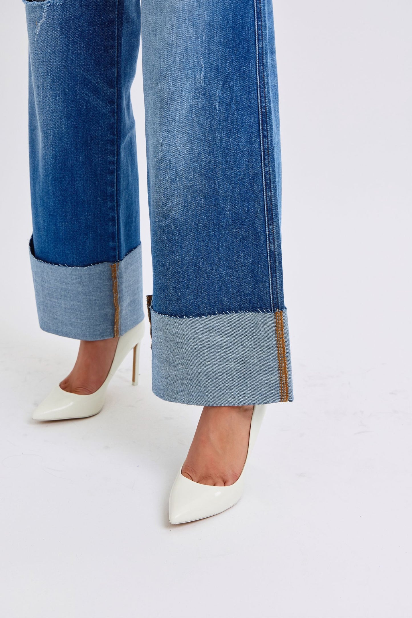 Close up detail of cuffed hem on Judy Blue Nare Plus Size Wide Leg Jeans with distressed accents.