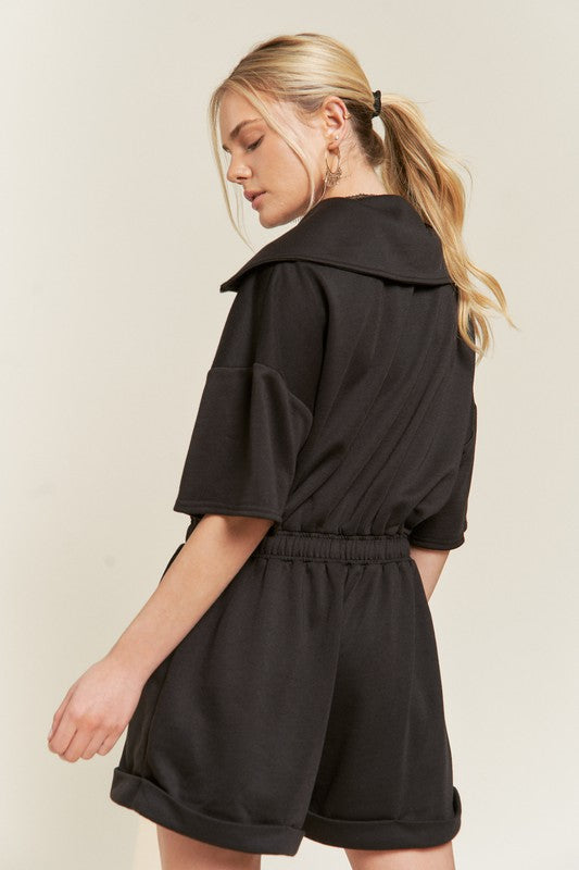 Back of black Clover Plus Size romper showing elastic waistband and soft terry fabric.