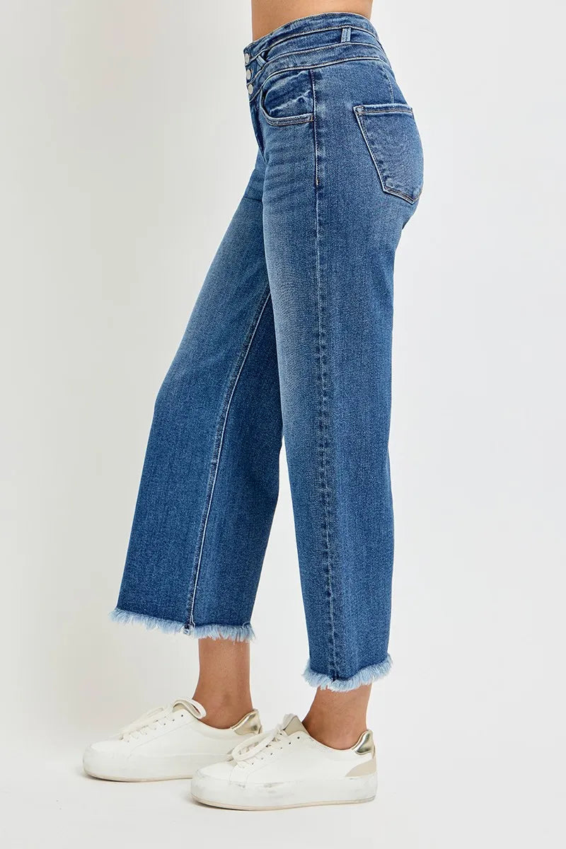 Dark wash cropped wide leg jeans showing wide band waist and relaxed silhouette.