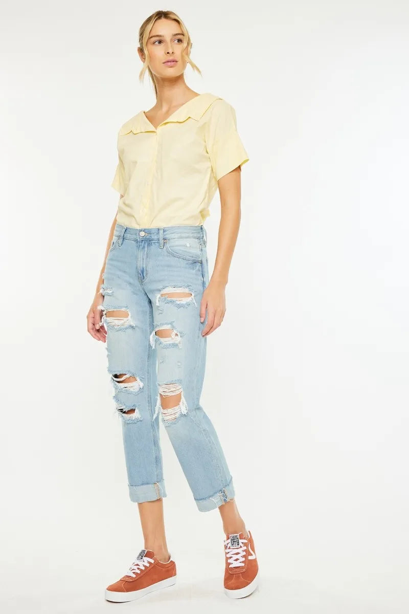 Relaxed side angle of Kancan Cordelia Distressed Boyfriend Jeans showing mid rise fit and casual silhouette.