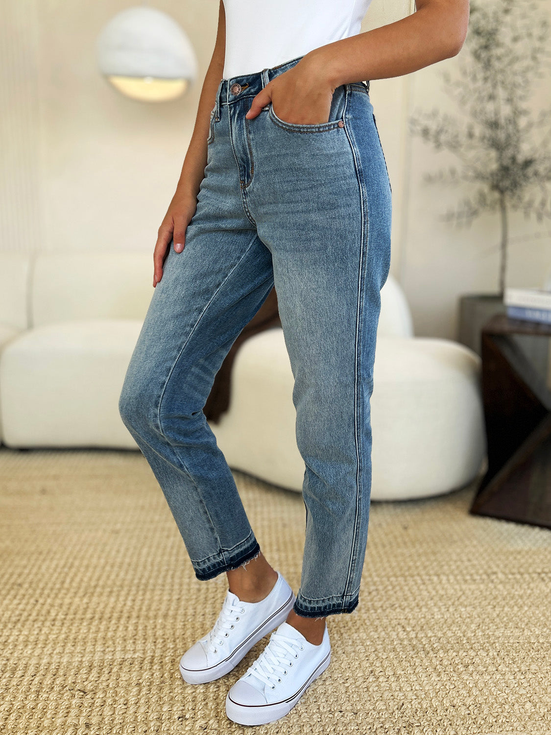 Front view of Merrill Mid Rise Release Hem Jeans in medium wash with relaxed fit and raw hem.