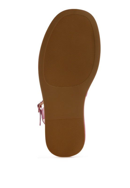 Bottom view of pink woven raffia flatform sandals showing textured rubber sole for grip and durability.