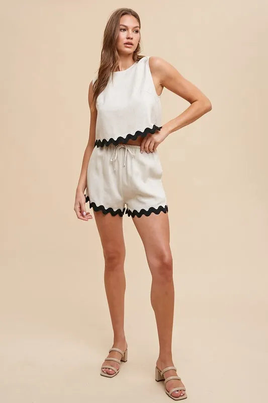 Natural color two-piece set featuring Ric Rac trim, round neck sleeveless top, and drawstring shorts.