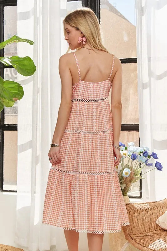 Emilia peach tiered gingham dress with frill accents, fully lined body, and slightly stretchy fabric.