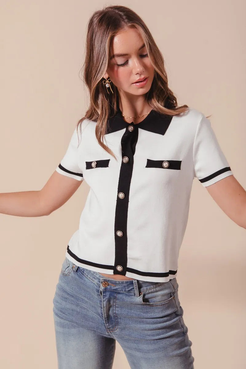 Front view of model in Novah Sweater Shirt Top with rolled sleeves, showing black trim and classic button design