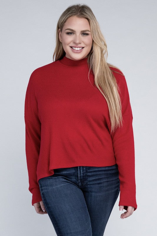 Plus size model wearing Raya Curvy Plus Drop Shoulder Top in red with mock neck, front view.