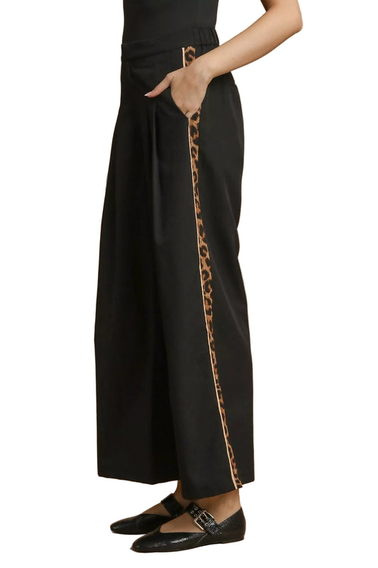 Side view showing contrast leopard trim detail on wide-leg pants