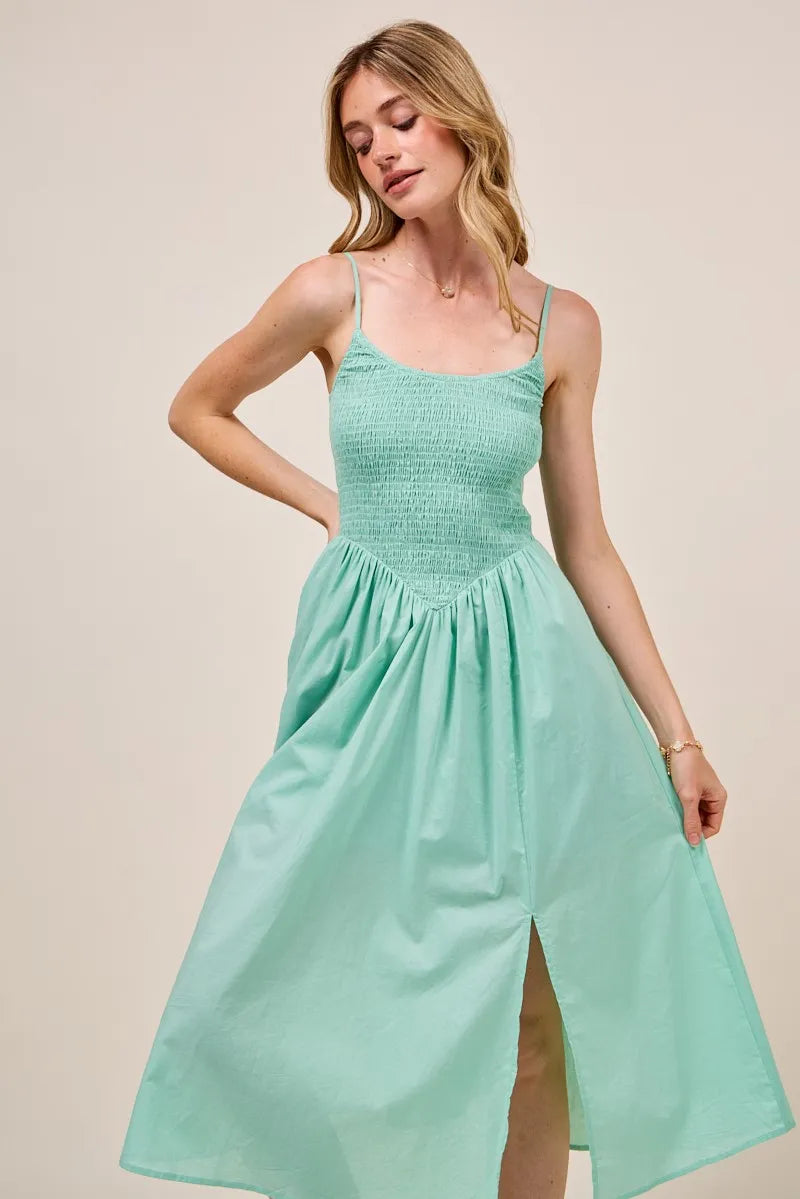 Front view of the Berkley Smocked Midi Dress in sage, focusing on the textured smocked bodice and delicate spaghetti straps.