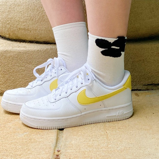 Woman wearing white flower socks from Insiders Only Set styled with sneakers.