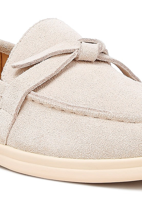 Close-up detail of Nautica beige suede loafers with knot vamp.