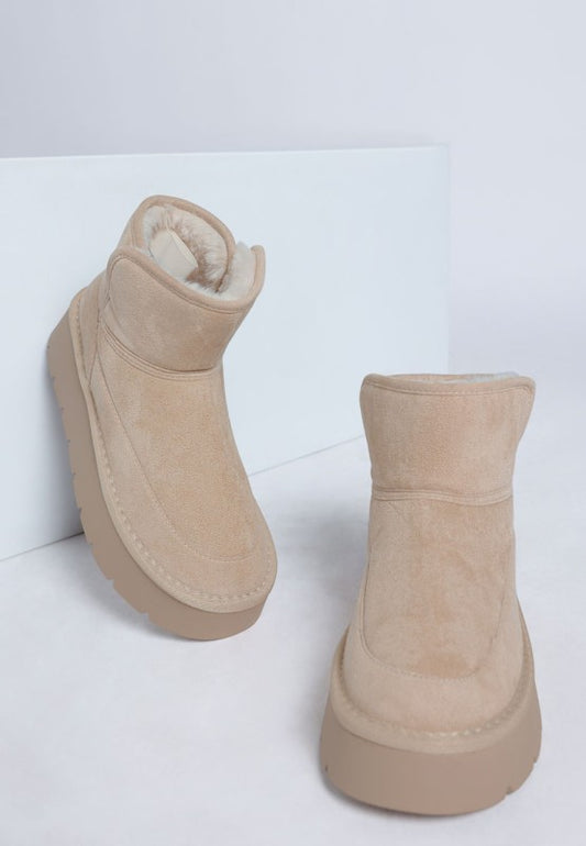 Front angle of Sand Holias Chunky Heeled Snow Boots with chunky heel, faux suede finish, and paneling detail.
