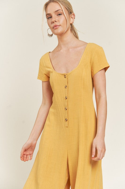 Close-up of mustard Seona Linen Jumpsuit highlighting button closure and soft linen texture.