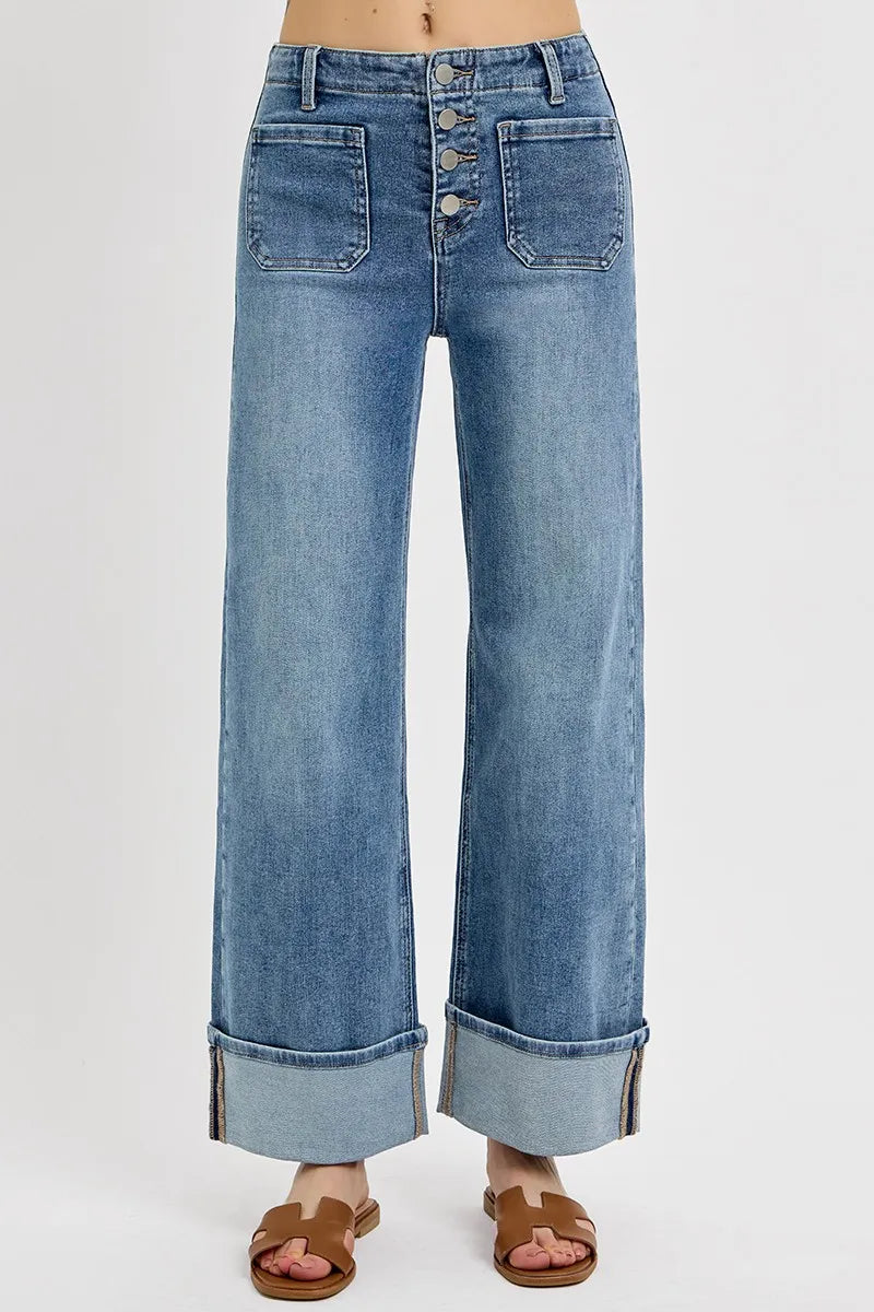 Close-up front view of Asher high rise jeans highlighting button fly closure, front patch pockets, and medium wash wide leg style by RISEN