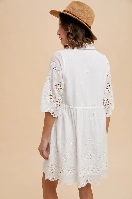 Back view of the Kiaan Mini Shirt Dress in ivory cotton, showing scalloped hem and relaxed fit.