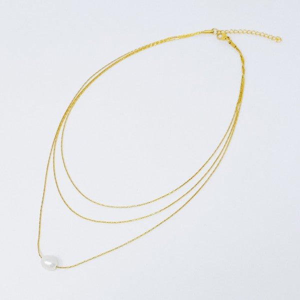 Flat lay of layered freshwater pearl pendant necklace with extender clasp