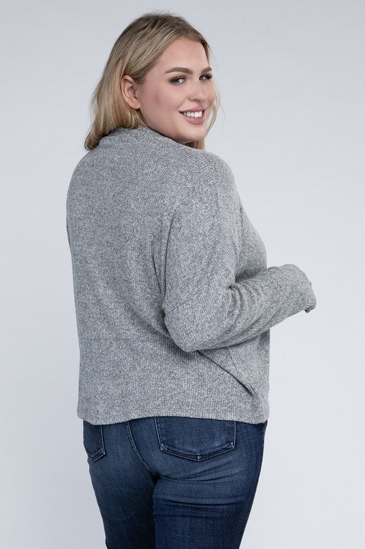 Plus size model wearing Raya Curvy Plus Drop Shoulder Top in heather gray with mock neck.