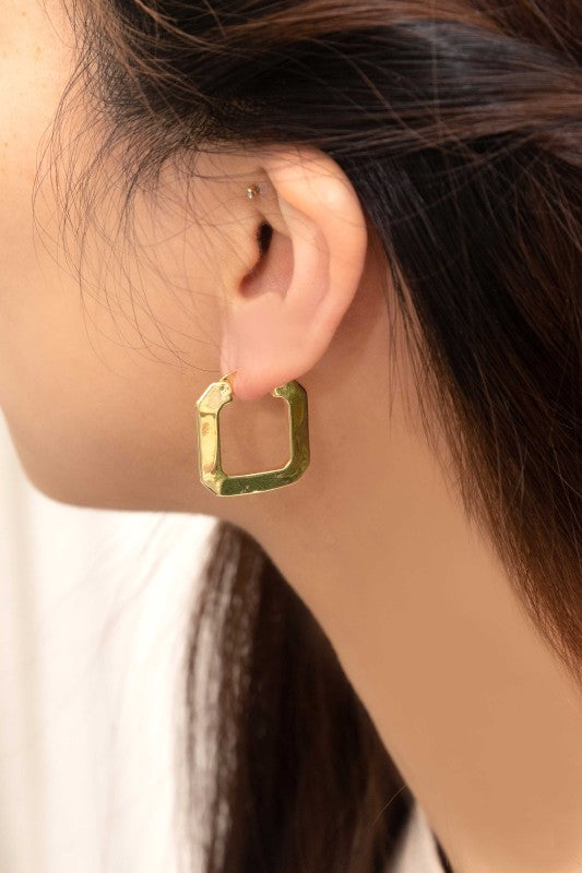 Woman wearing Modern Blocked Hoops in angled square gold design