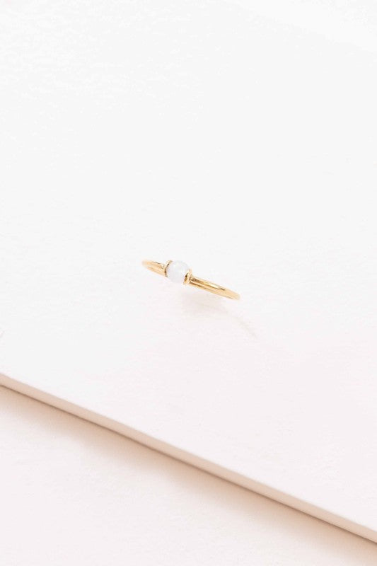 Becca White Stone Ring top view showing thin gold band and centered white stone detail