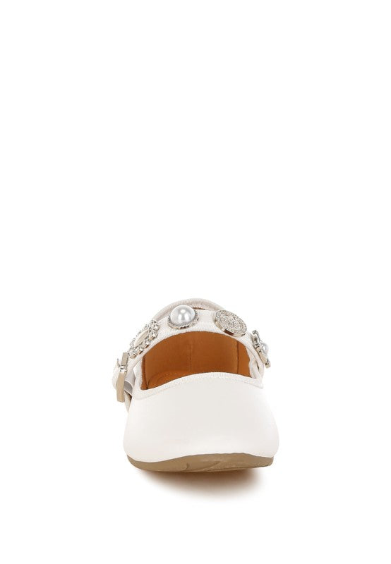 Front view of white Kavana Mary Jane Flats showcasing round toe design and detailed charm embellishments.