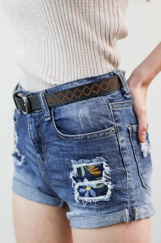 Sicilly Skinny Diamond Stitched Belt in black vegan leather worn with shorts, side angle view showing buckle and stitching.