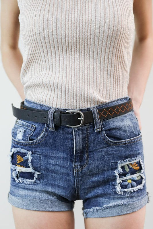 Sicilly Skinny Diamond Stitched Belt in black vegan leather worn with shorts, front view showing buckle and diamond stitching.