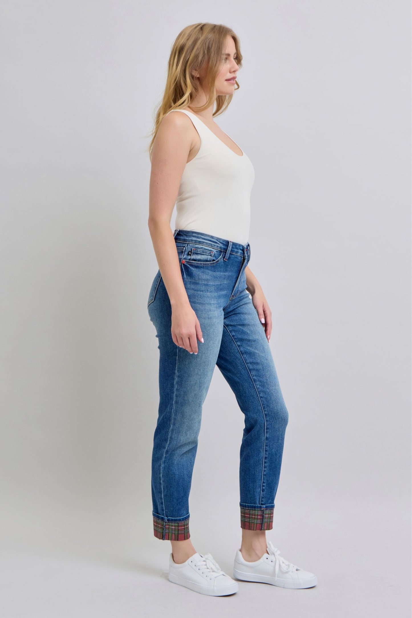 Side view of Logan Plaid Cuff Straight Leg Jeans in medium wash featuring mid waist and plaid cuffed hem.