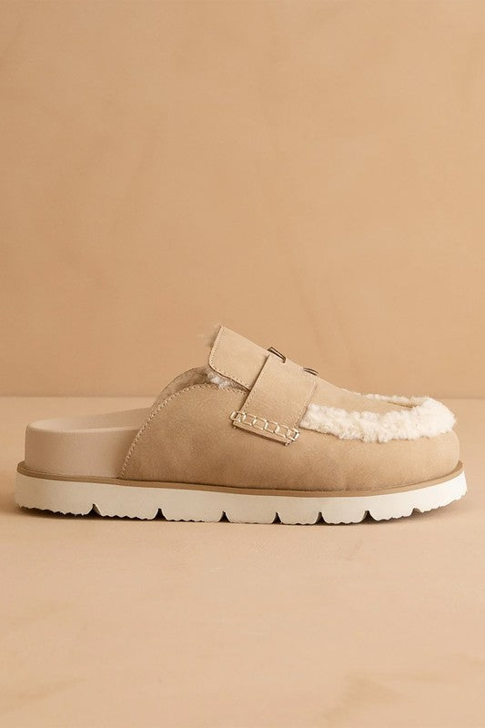 Side view of Avalon Khaki suede loafer mules with shearling trim, low heel, and rubber sole.