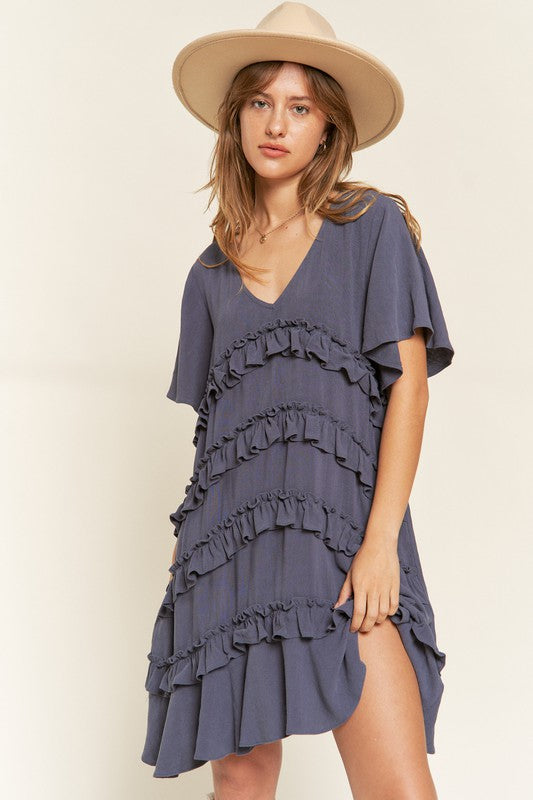 Model in Cement Gentry Curvy Tiered Ruffle Mini Dress, highlighting tiered design and ruffle trim.