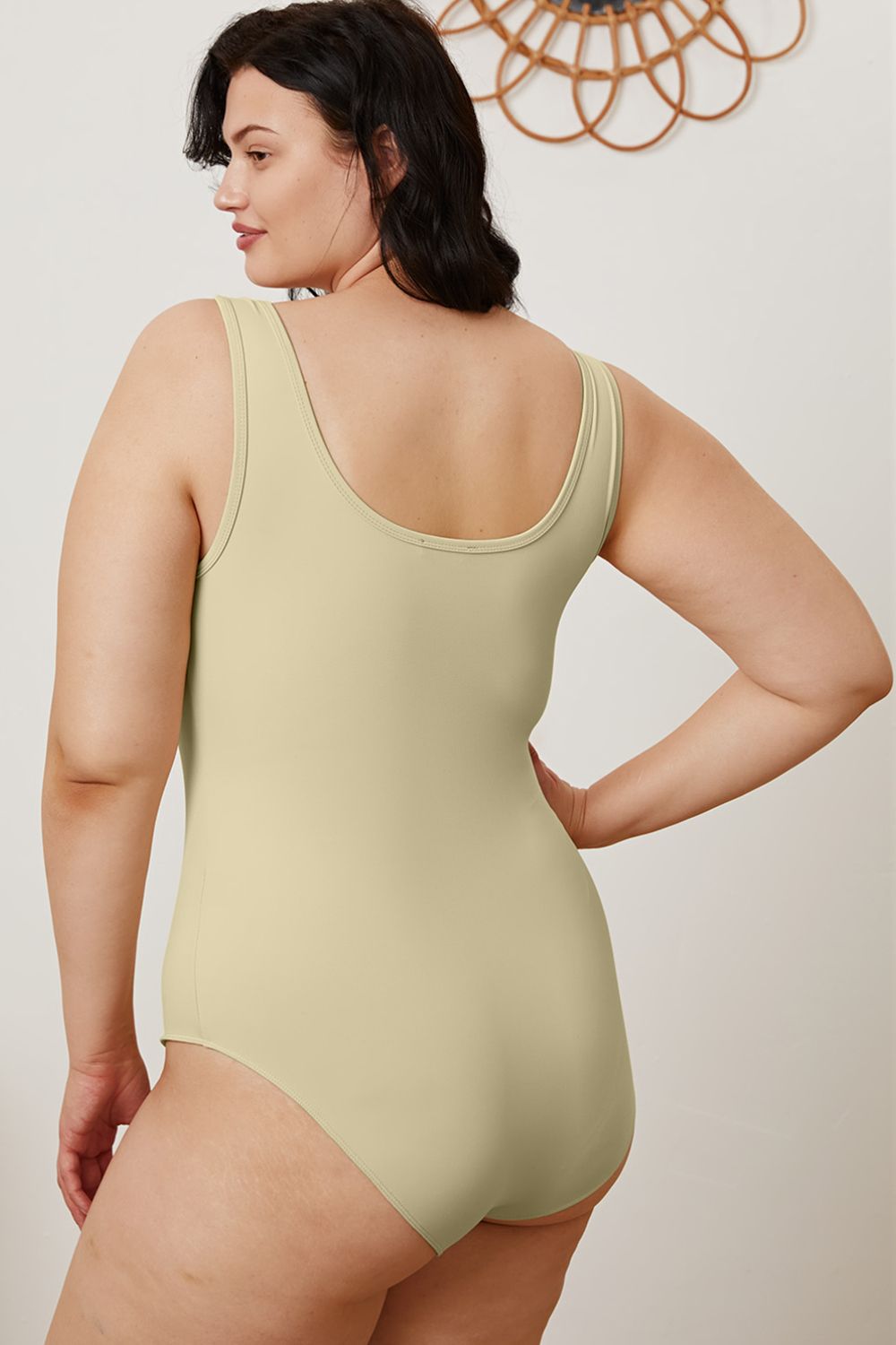 Plus size side angle of Sarah Beige Bodysuit highlighting sleek fit and comfort stretch.