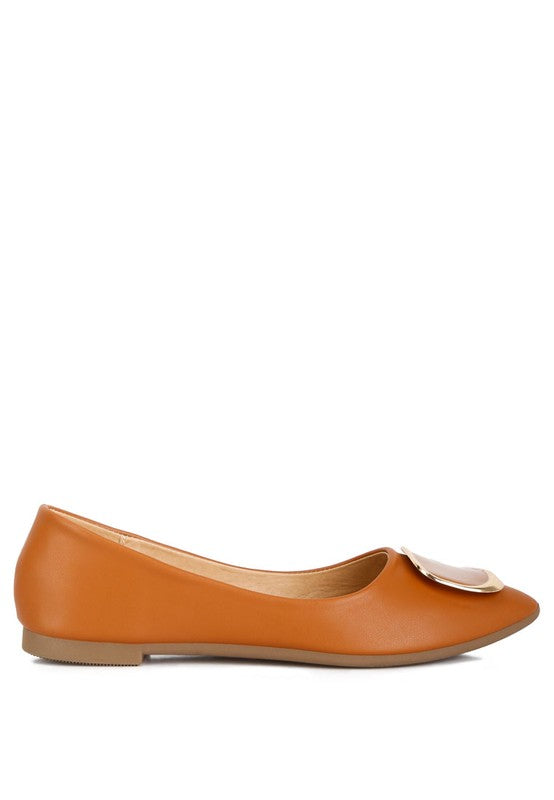 Side view of tan ballet flats with almond toe and brooch accent