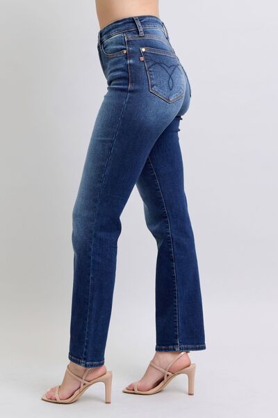 Side view of the Judy Blue Carson Washed Straight Leg Jeans in dark wash with mid-rise waist, slightly stretchy fabric, functional pockets, and a flattering straight leg cut. Made of 93.7% cotton, 5% polyester, and 1.3% spandex.