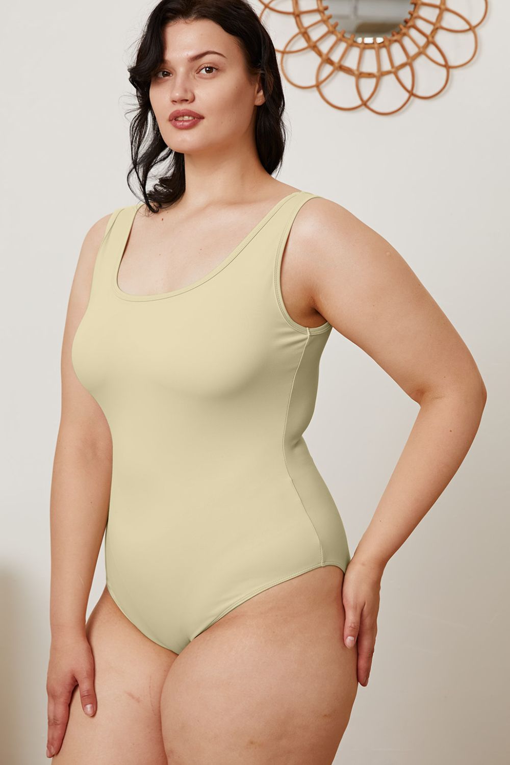 Plus size model in Sarah Beige Bodysuit with fitted silhouette and chic neckline.