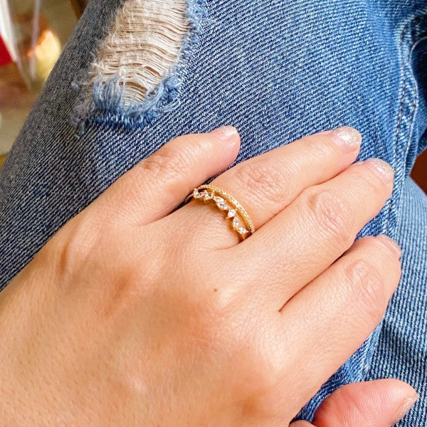 Colette Jeweled Ring on woman’s finger, gold band with shimmering cubic zirconia stones