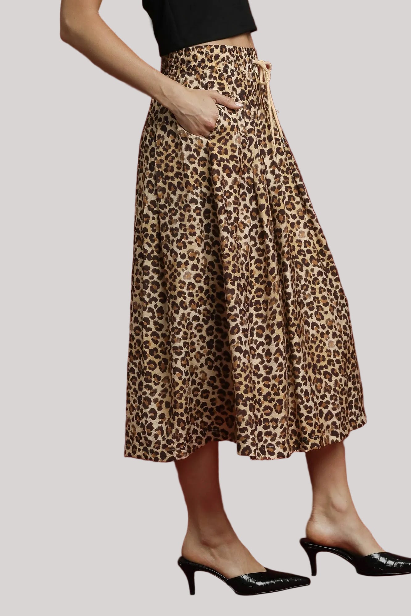 Side angle of Nala leopard midi skirt highlighting A-line fit.