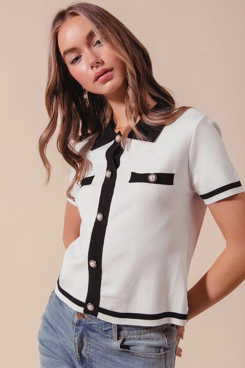 Side view of Novah ivory knit sweater shirt with black trim, structured fit and contrast edge details