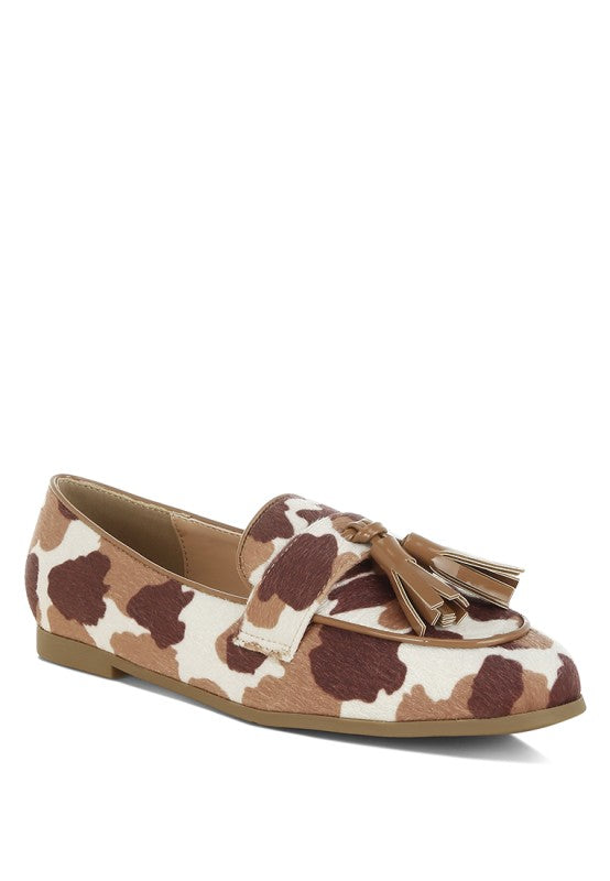 Front angled view of Moraug cowprint loafer featuring faux suede upper, tassel detail, and closed round toe – casual statement shoe by Rag Company