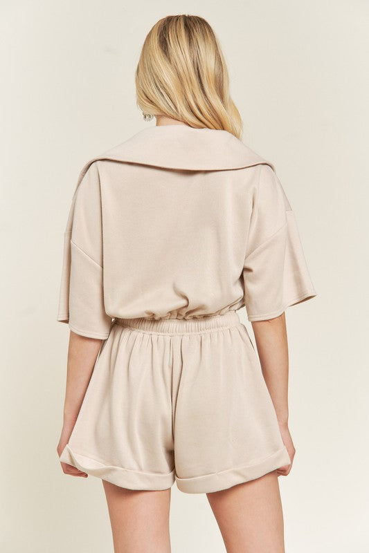 Back of beige Clover Plus Size romper with elastic waistband and relaxed fit.