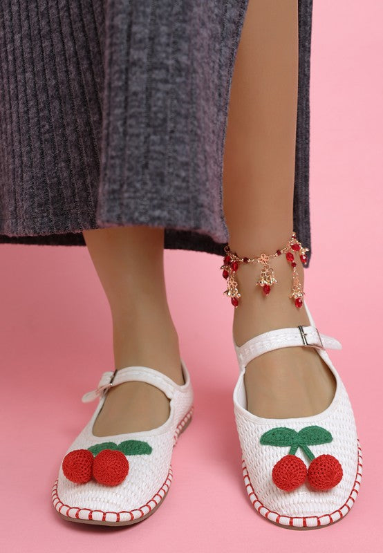 Front view of white Brunch Date Mary Jane Flats featuring woven raffia texture and cherry embellishment.