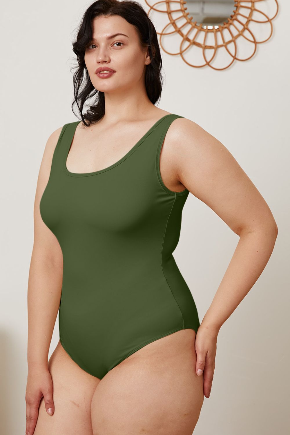 Plus size model in Sarah Hunter Green Bodysuit showing flattering square neckline.
