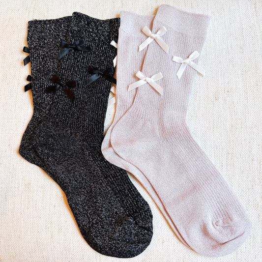 Pair of Shimmer Chic Bow Socks set in black and pink with subtle sparkle finish.